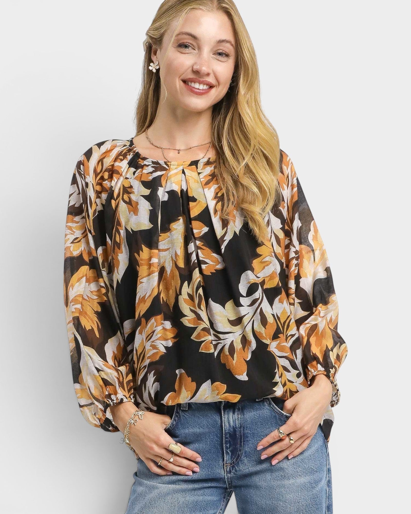 Beach Rose Co. black floral print blouse with gathered neckline, billowy sleeves, and elastic cuffs. Rayon/nylon blend.
