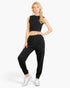 Beach Rose Co. black French Terry tank top and joggers set worn by a blonde model with white sneakers