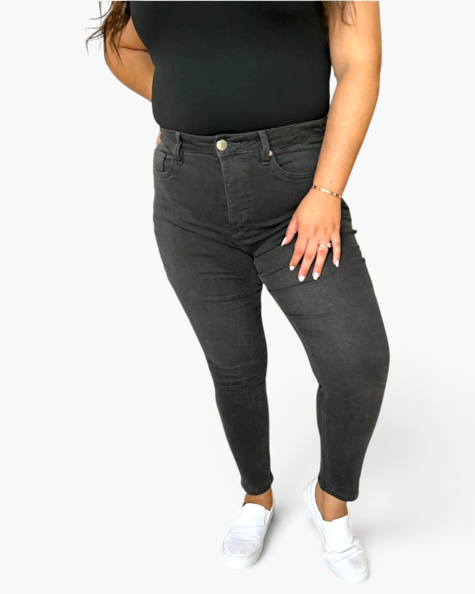 Beach Rose Co. high rise black skinny jeans with tummy control, worn by a model with a black top and white sneakers.
