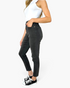 Beach Rose Co. high-rise black skinny jeans with tummy control and pockets worn by a model in a side profile view.