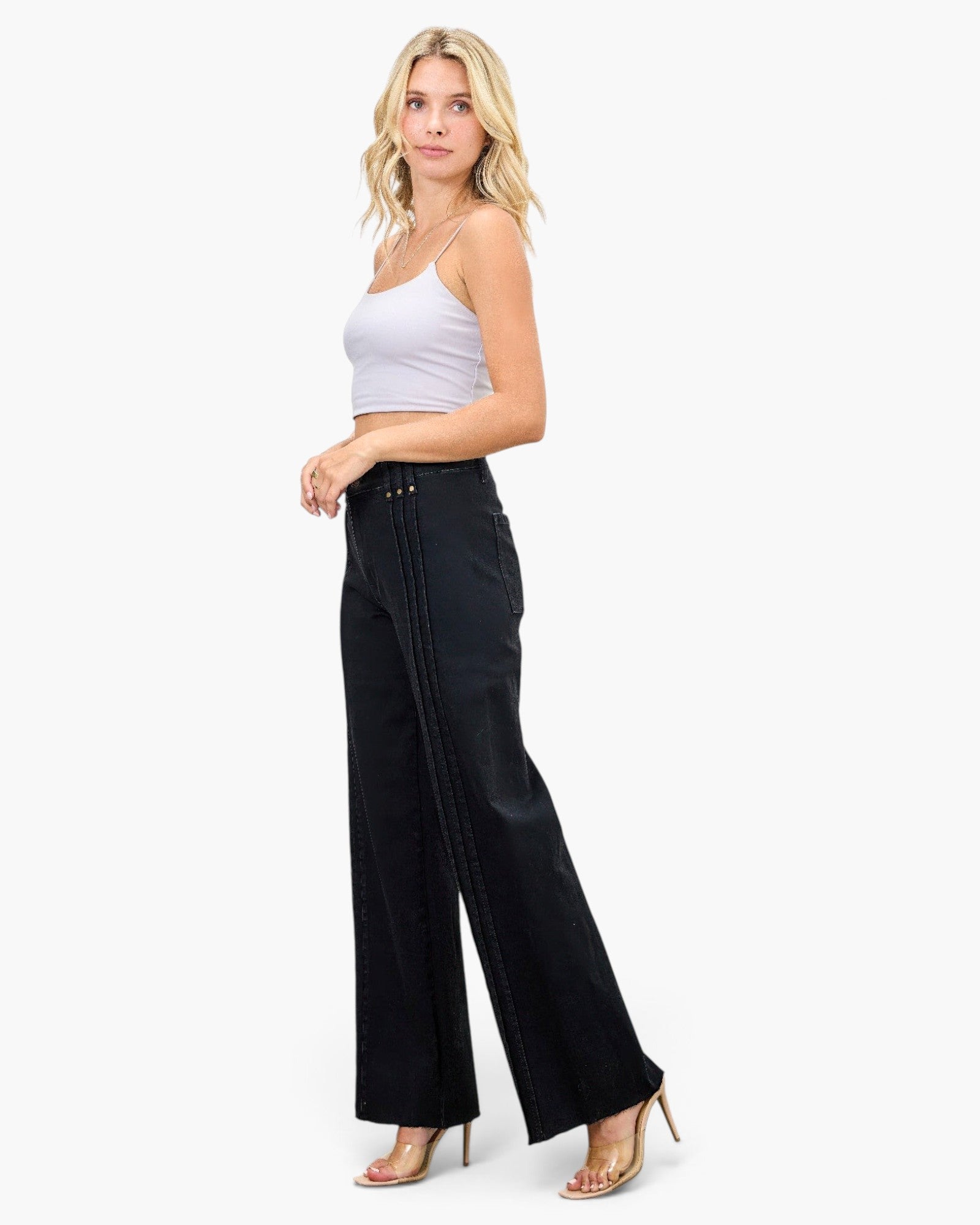 Beach Rose Co. high-rise straight-leg black jeans with front pleat detailing worn by a blonde model in a white top.