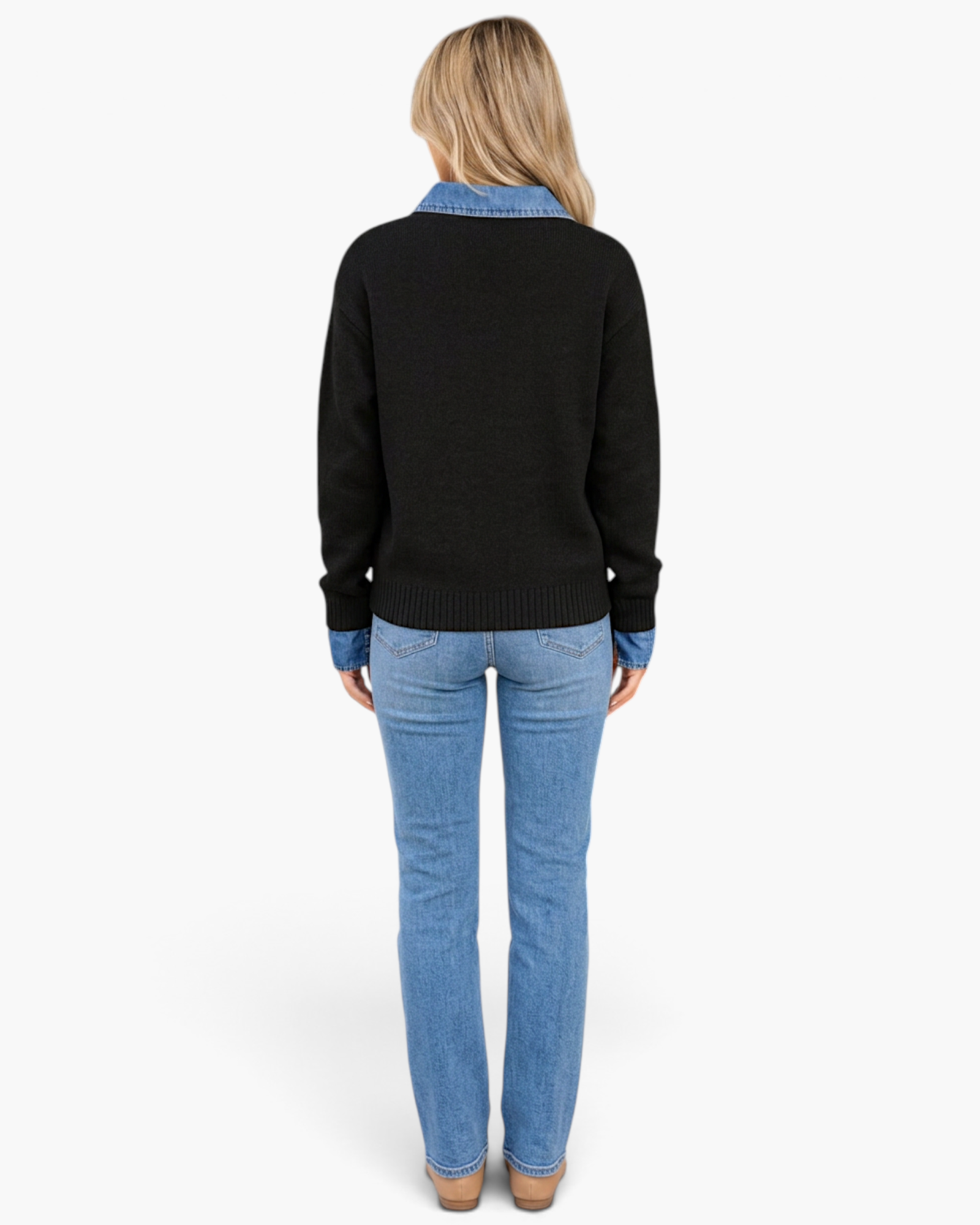 Back view of a blonde woman wearing a Beach Rose Co. black knit sweater with a denim collar and cuffs over blue jeans.