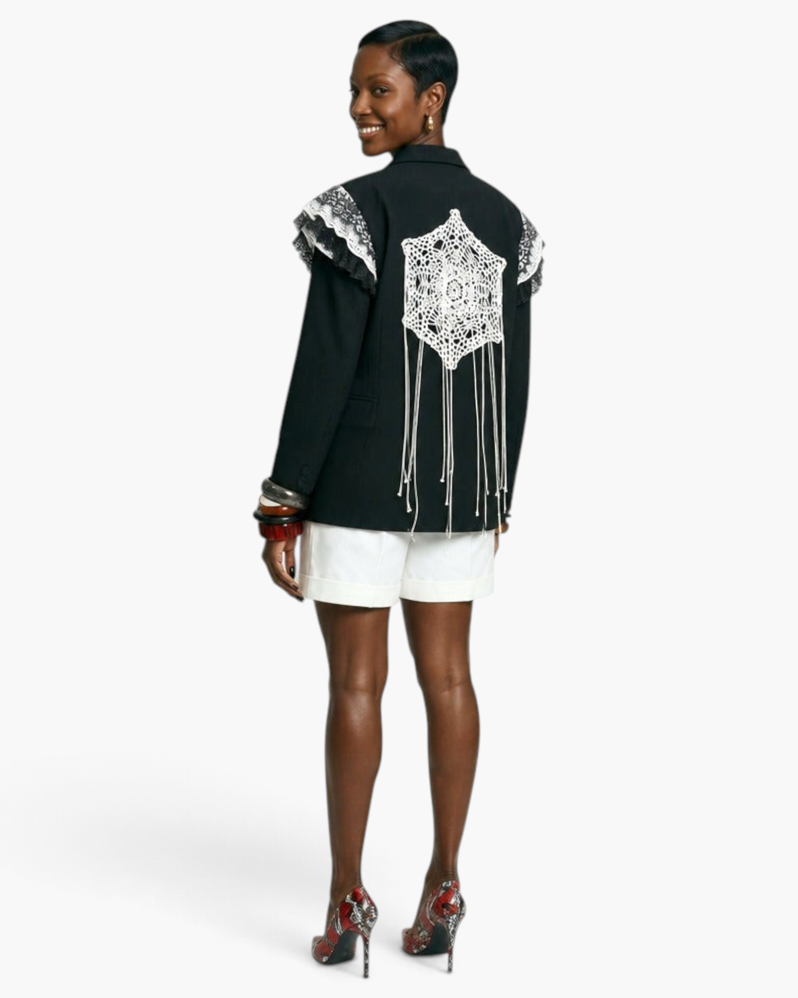 Beach Rose Co. black blazer featuring a crochet lace back panel with hanging strands and lace-trimmed shoulders.