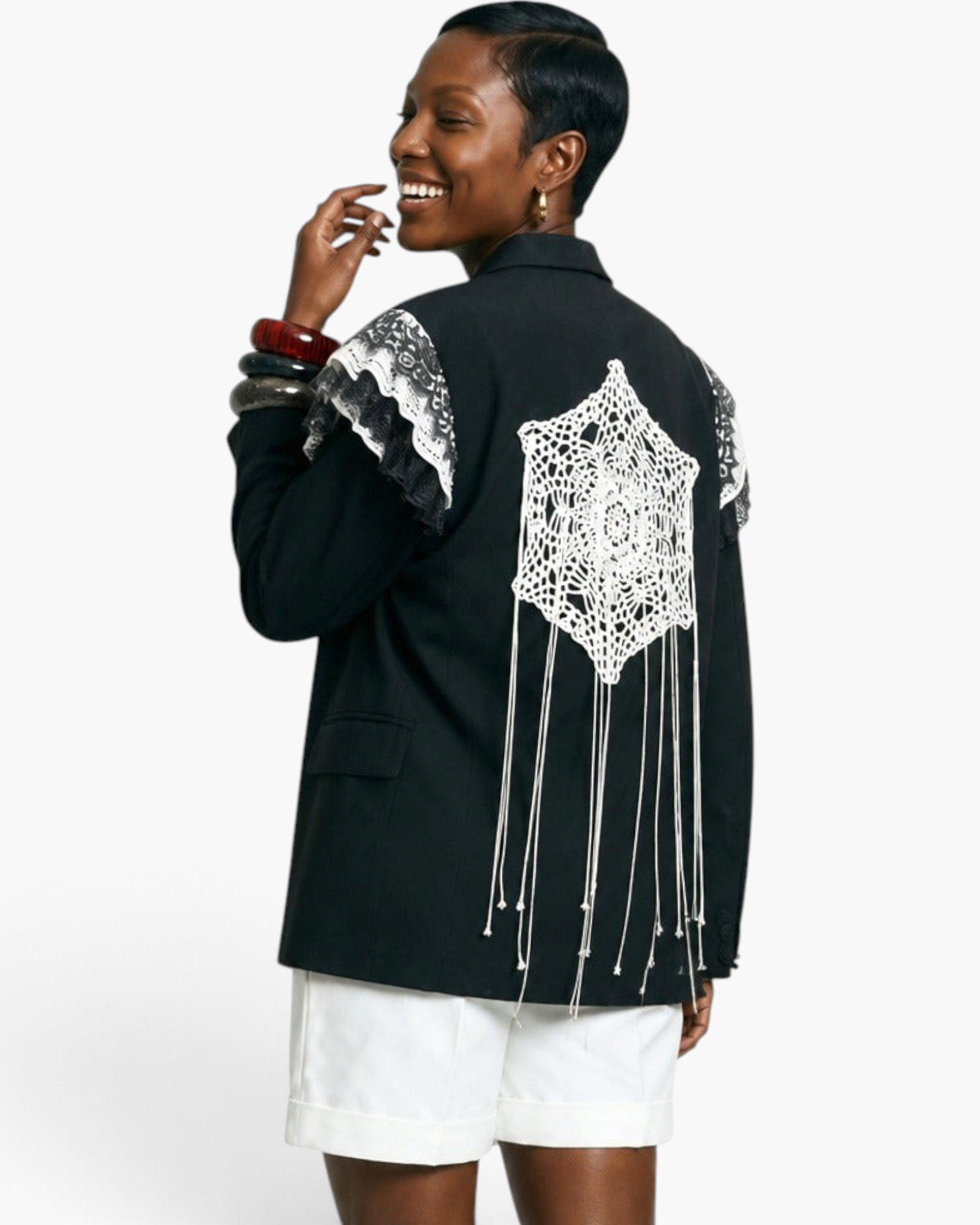 Beach Rose Co. black blazer featuring white crochet lace back panel with hanging fringe and lace-trimmed shoulders.