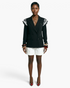 Model wearing a Beach Rose Co. black double-breasted blazer with lace-trimmed shoulders and white tailored shorts.