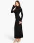 Beach Rose Co. black mock neck crop top with bell sleeves and matching maxi skirt worn by a model in beige heels.