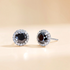 Beach Rose Co. black moissanite stud earrings with a clear zircon halo set in platinum-plated sterling silver.