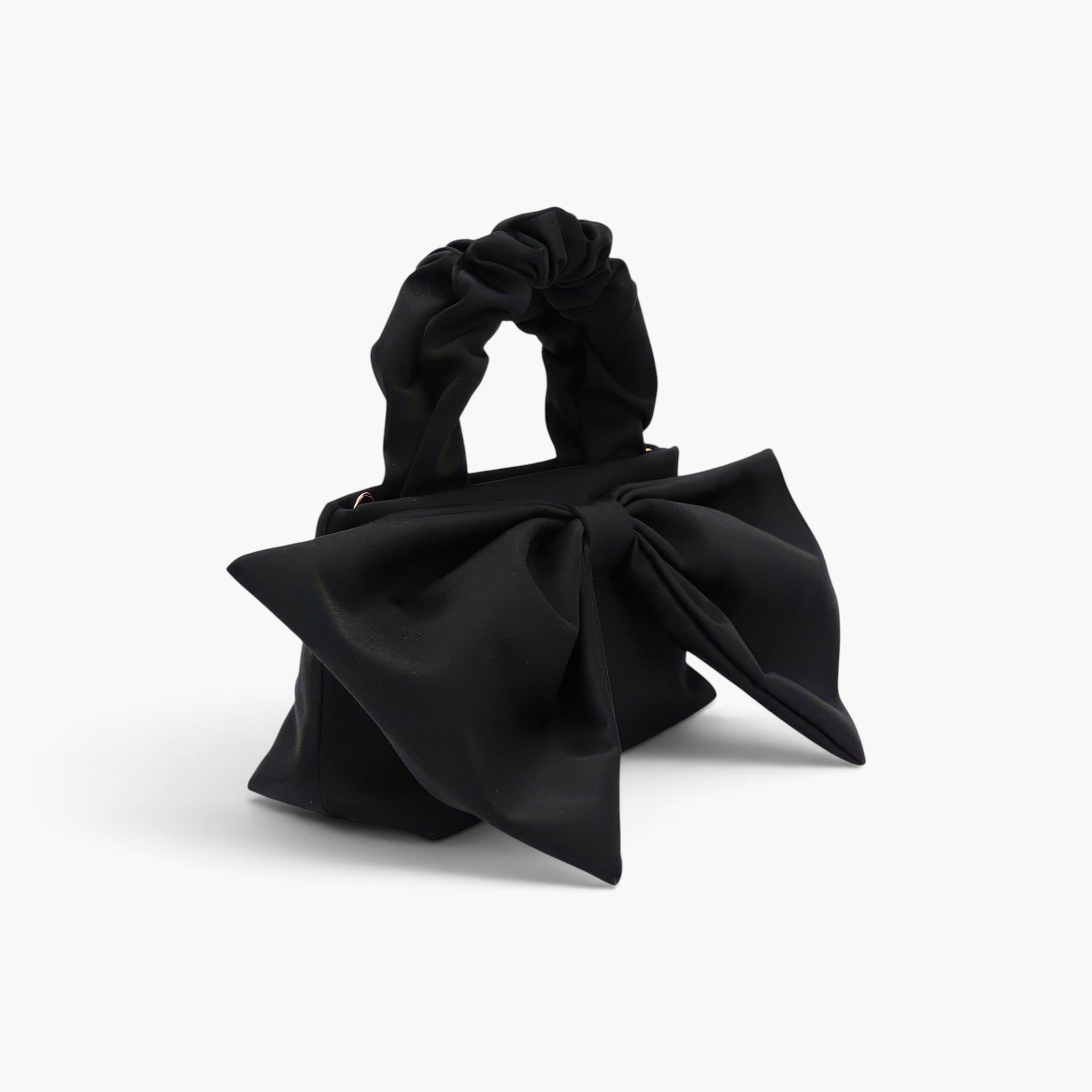 Beach Rose Co. black nylon clutch featuring a large front bow and a gathered scrunchie-style top handle.