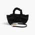 Beach Rose Co. black nylon clutch featuring a large front bow, a ruched top handle, and a detachable gold chain strap.