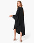 Beach Rose Co. black matte crepe one-sleeve dress with an asymmetrical hem worn by a model on a white background.