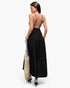Beach Rose Co. black sleeveless maxi dress with an open back, high waist, and tiered skirt, worn by a woman.