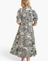 Beach Rose Co. black and ivory cotton midi dress with paisley print, collared neckline, and puff sleeves, back view.