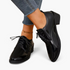 Beach Rose Co. black patent lace-up oxford shoes with a low block heel worn with cropped blue jeans