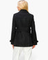 Beach Rose Co. black mid-length peacoat with back button detail worn by a blonde model against a white background