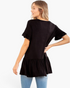 Beach Rose Co. black peplum top with ruffle sleeves and gathered hem worn by a woman, back view