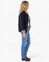 Beach Rose Co. black quilted jacket with leopard print cuffs worn by a blonde model in profile view
