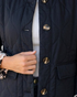 Beach Rose Co. black quilted jacket featuring curved stitching, glossy buttons, and leopard-print cuffs.