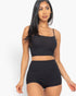 Beach Rose Co. black ribbed cami crop top and matching ruched shorts set worn by a model against a white background.