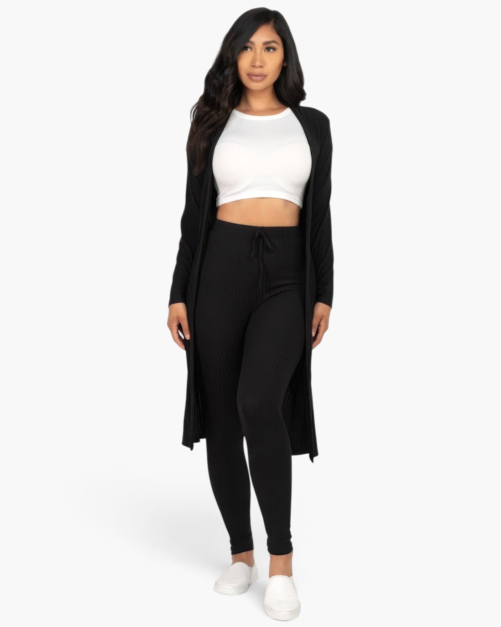 Beach Rose Co. black ribbed long cardigan and leggings set worn by a model with a white crop top and slip-on shoes