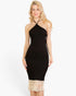 Beach Rose Co. black ribbed midi dress with a halter neck and cream-colored fringe hem worn by a blonde model.