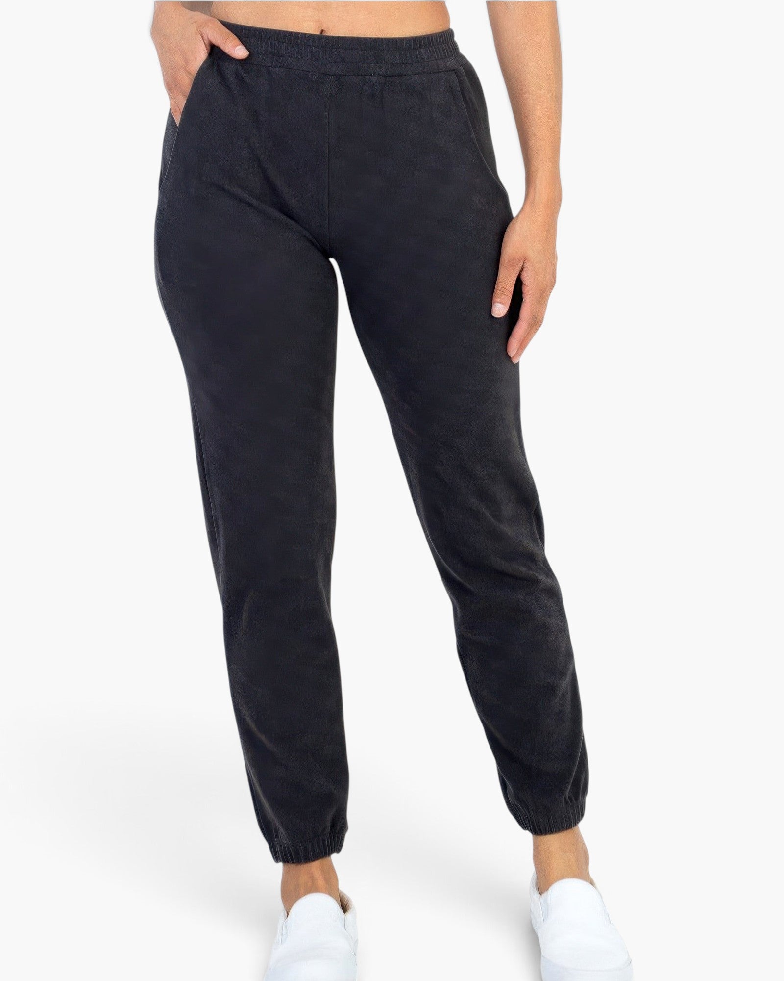 Beach Rose Co. black ribbed joggers with side pockets and a relaxed fit, worn by a model in a studio setting.
