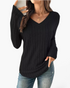 Beach Rose Co. black long sleeve ribbed knit top with a wide V-neckline and curved hem worn with jeans