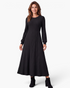 Beach Rose Co. black ribbed knit midi dress with long balloon sleeves and a flared skirt worn by a smiling woman.