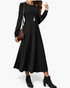 Beach Rose Co. black ribbed knit midi dress with long balloon sleeves, defined waist, and flared skirt on a model.