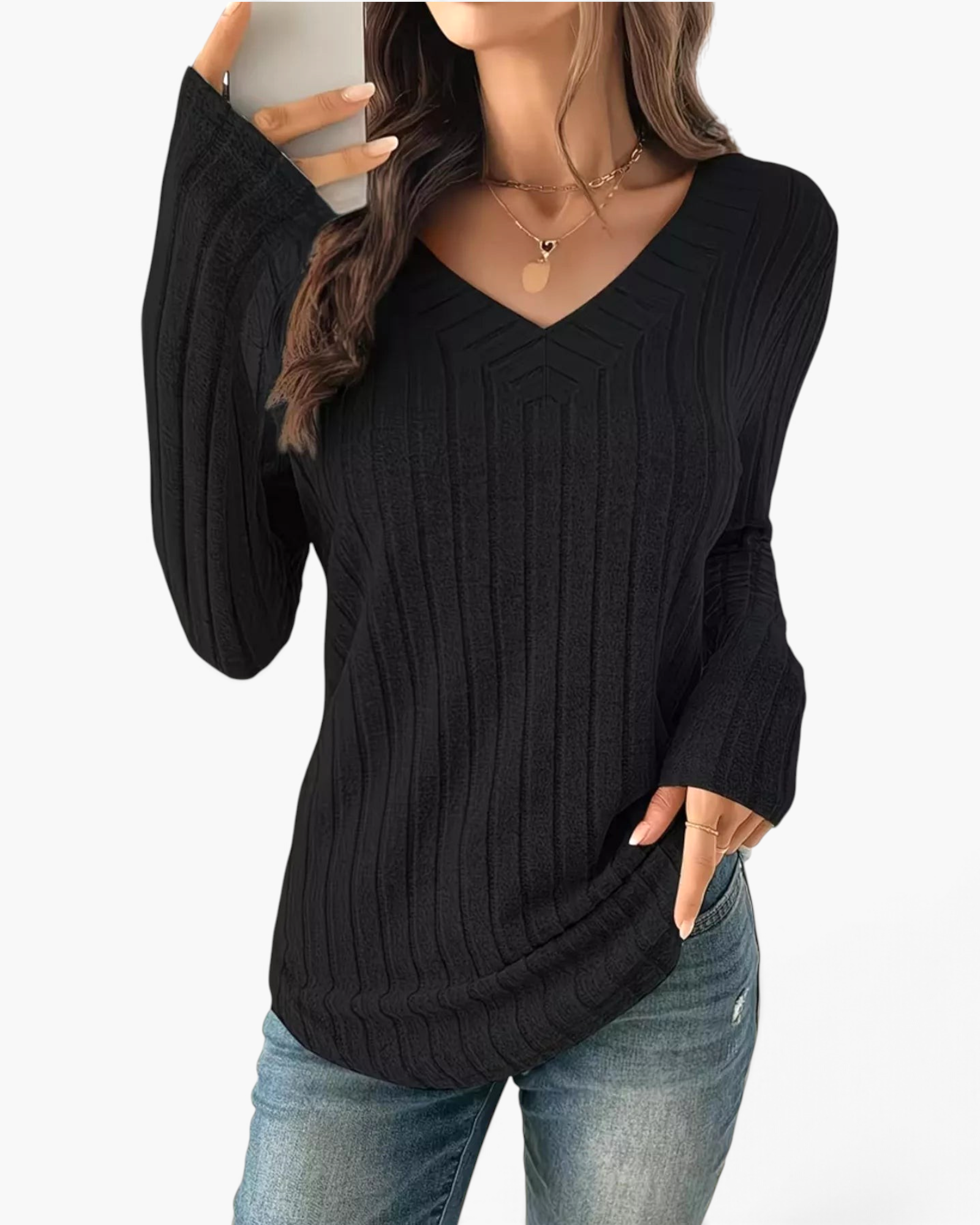 Beach Rose Co. black long sleeve ribbed knit top with a wide V-neckline and curved hem worn with blue jeans