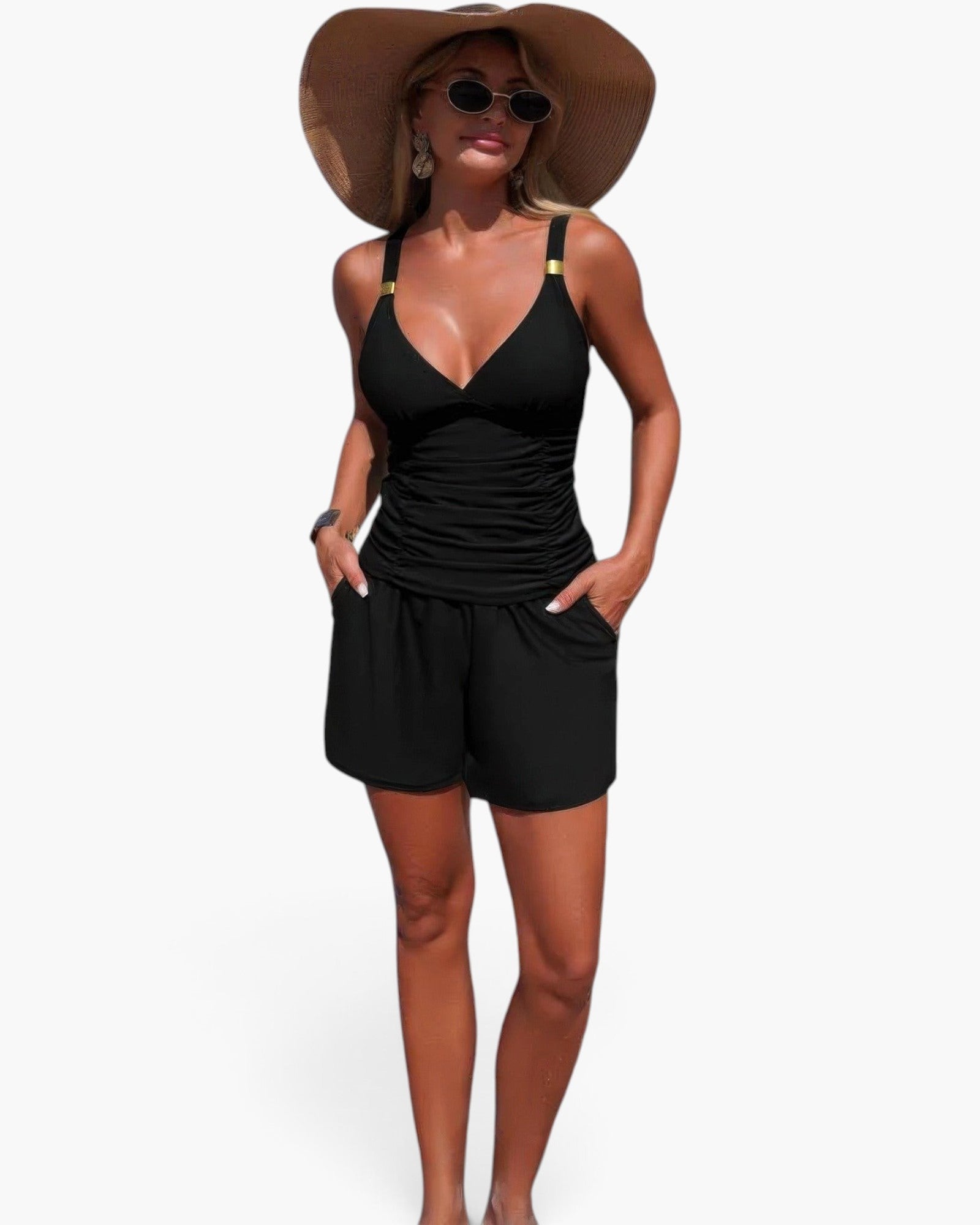 Beach Rose Co. black two-piece bikini with ruched V-neck top and shorts with pockets worn by a woman on the beach