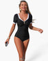 Beach Rose Co. black one-piece swimsuit with white contrast trim, short sleeves, and flattering ruched front detail.