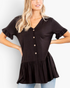 Beach Rose Co. black V-neck peplum top with button front and ruffle sleeve cuffs worn by a blonde model