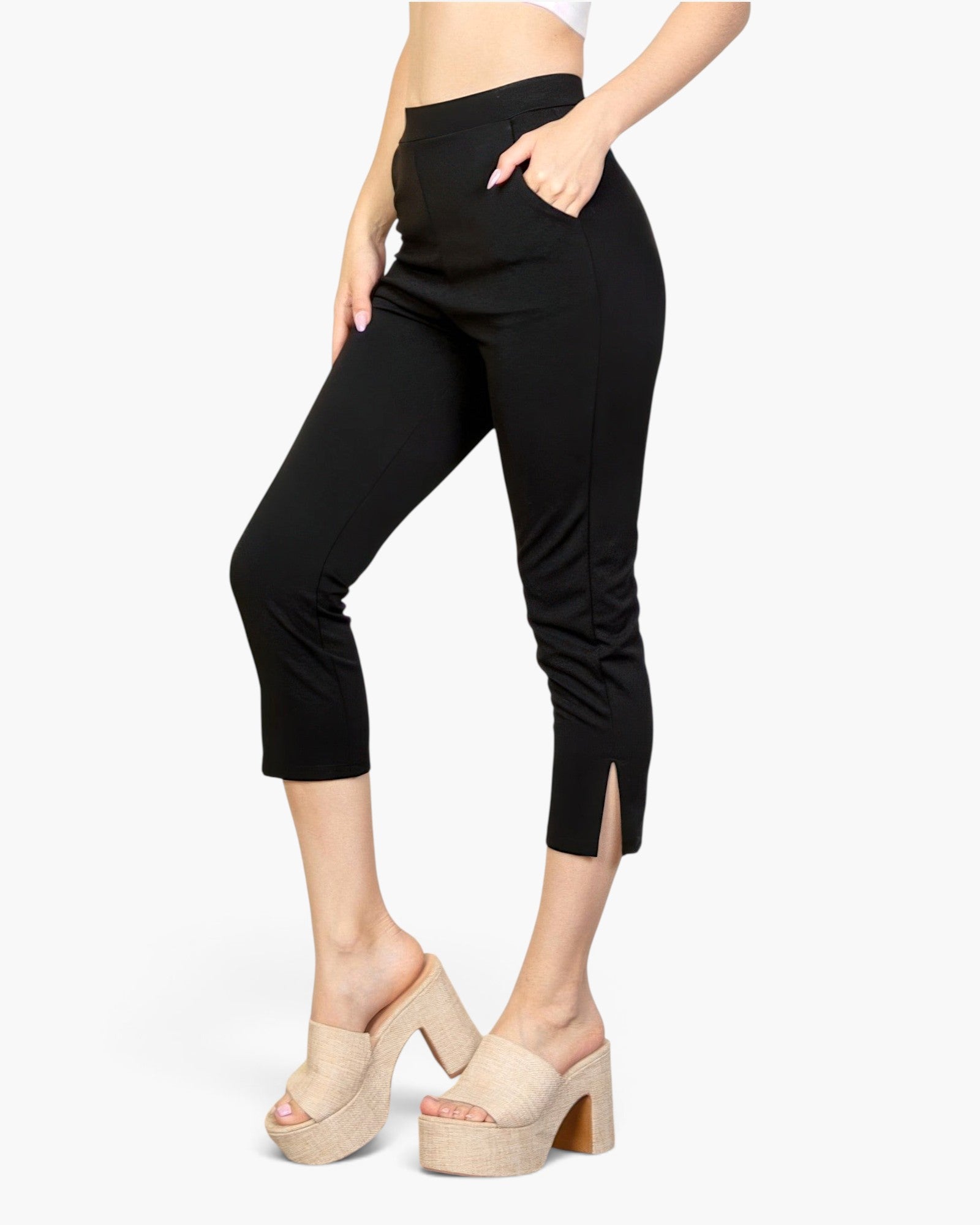 Beach Rose Co. black cropped pants featuring a slit hem, elasticized waist, and soft stretch crepe fabric on a model.