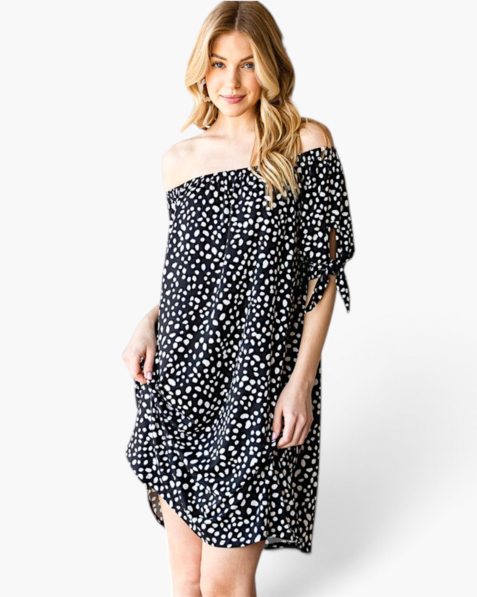 Beach Rose Co. black and ivory spotted off-shoulder dress with tie-sleeve details on a blonde model