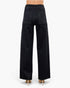 Beach Rose Co. black high-rise straight-leg jeans with back pockets, viewed from behind on a model in heels.