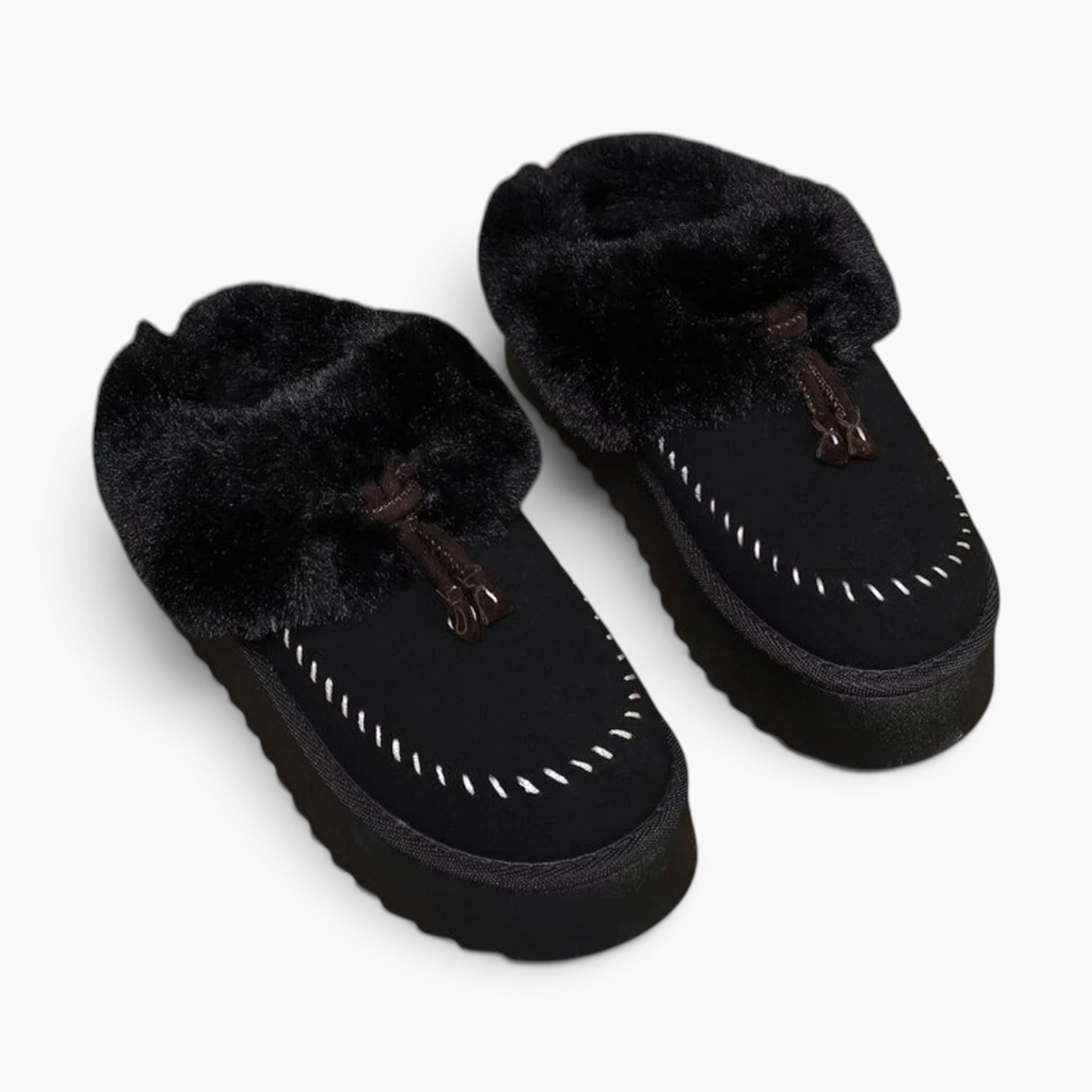 Beach Rose Co. black suede platform clogs with plush faux fur trim, moccasin stitching, and decorative tassels.