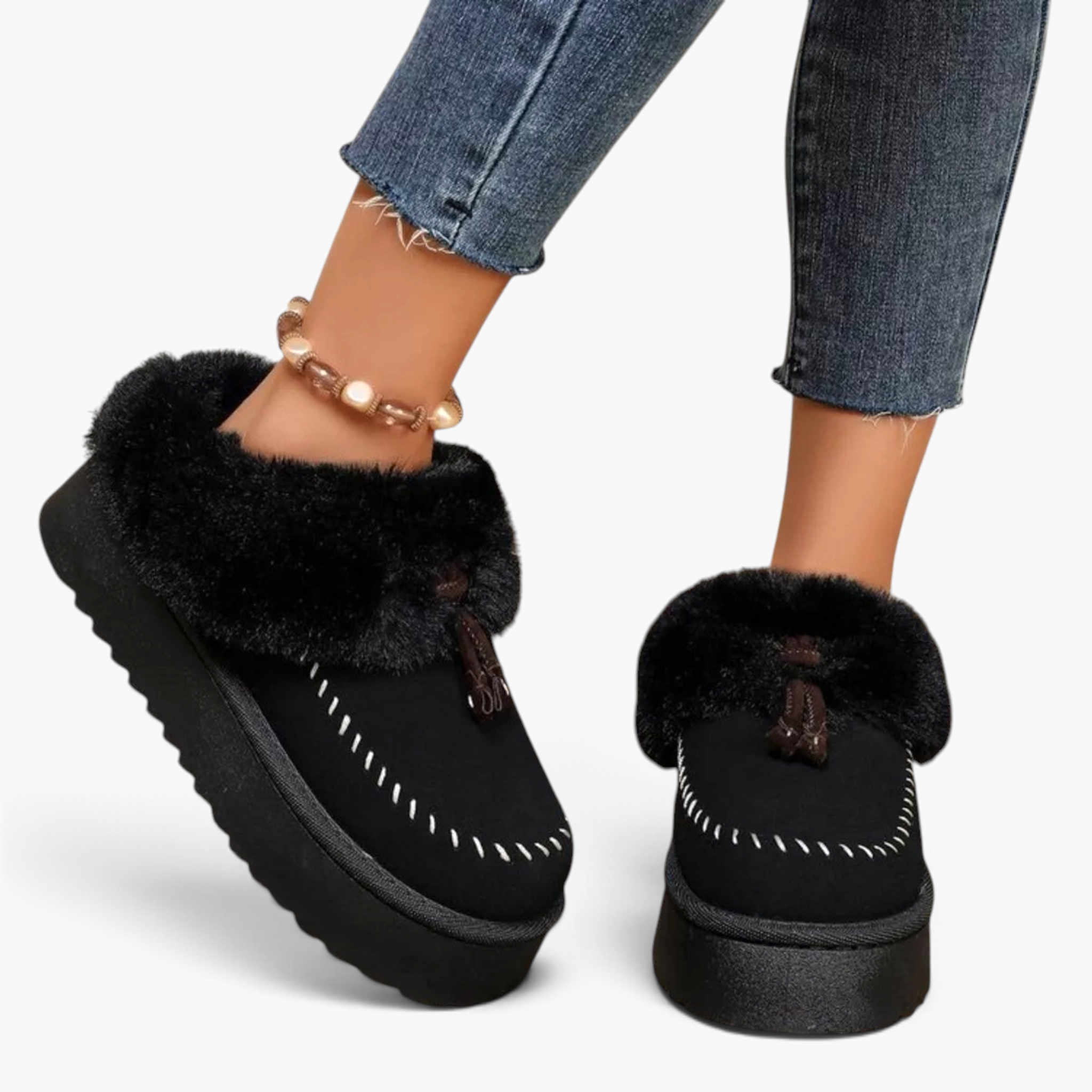 Beach Rose Co. black suede platform clogs with plush faux fur trim, moccasin stitching, and decorative tassels.