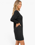 Beach Rose Co. black textured knit sweater dress with long sleeves and a round neckline worn by a blonde model.