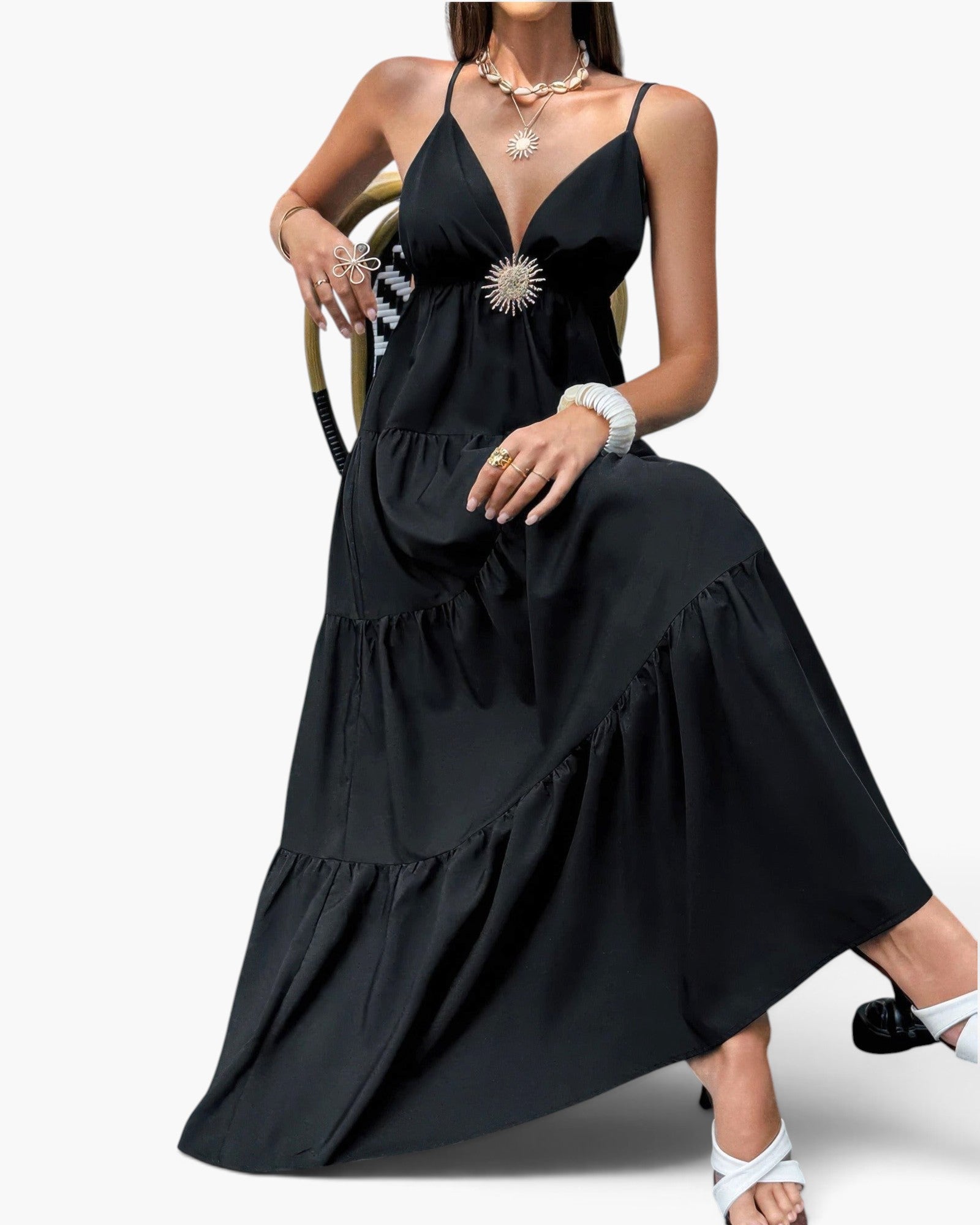 Beach Rose Co. black sleeveless maxi dress with high waist, tiered skirt, and decorative brooch detail