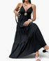 Beach Rose Co. black sleeveless maxi dress with high waist, tiered skirt, and decorative brooch detail