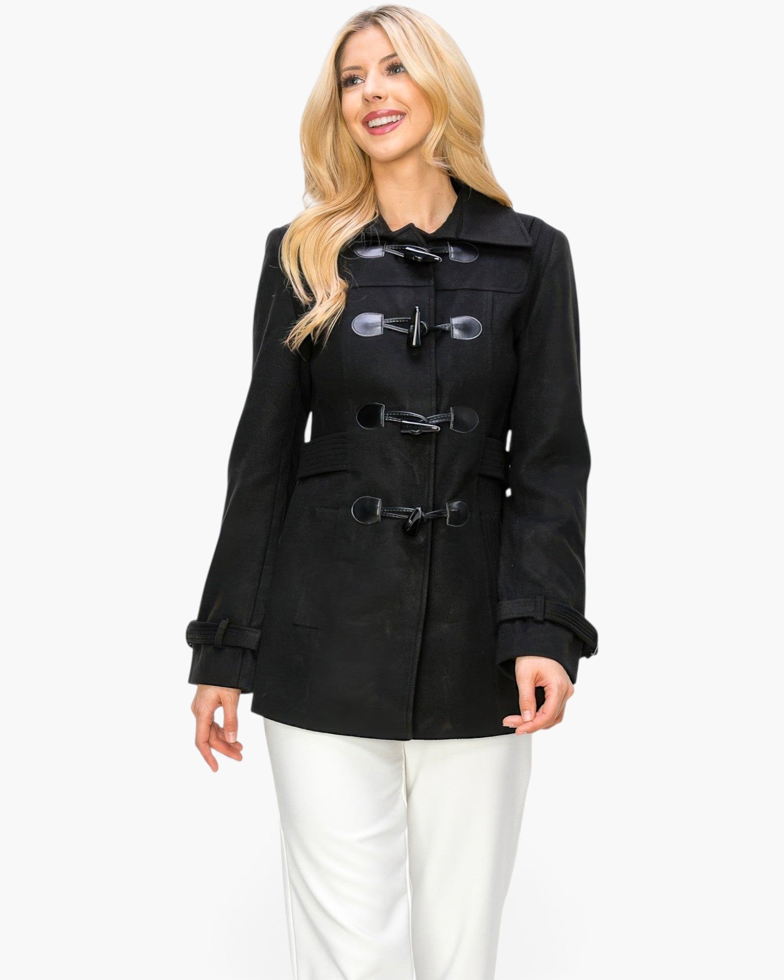 A blonde model wearing a black Beach Rose Co. mid-length peacoat with toggle button closures and side pockets.
