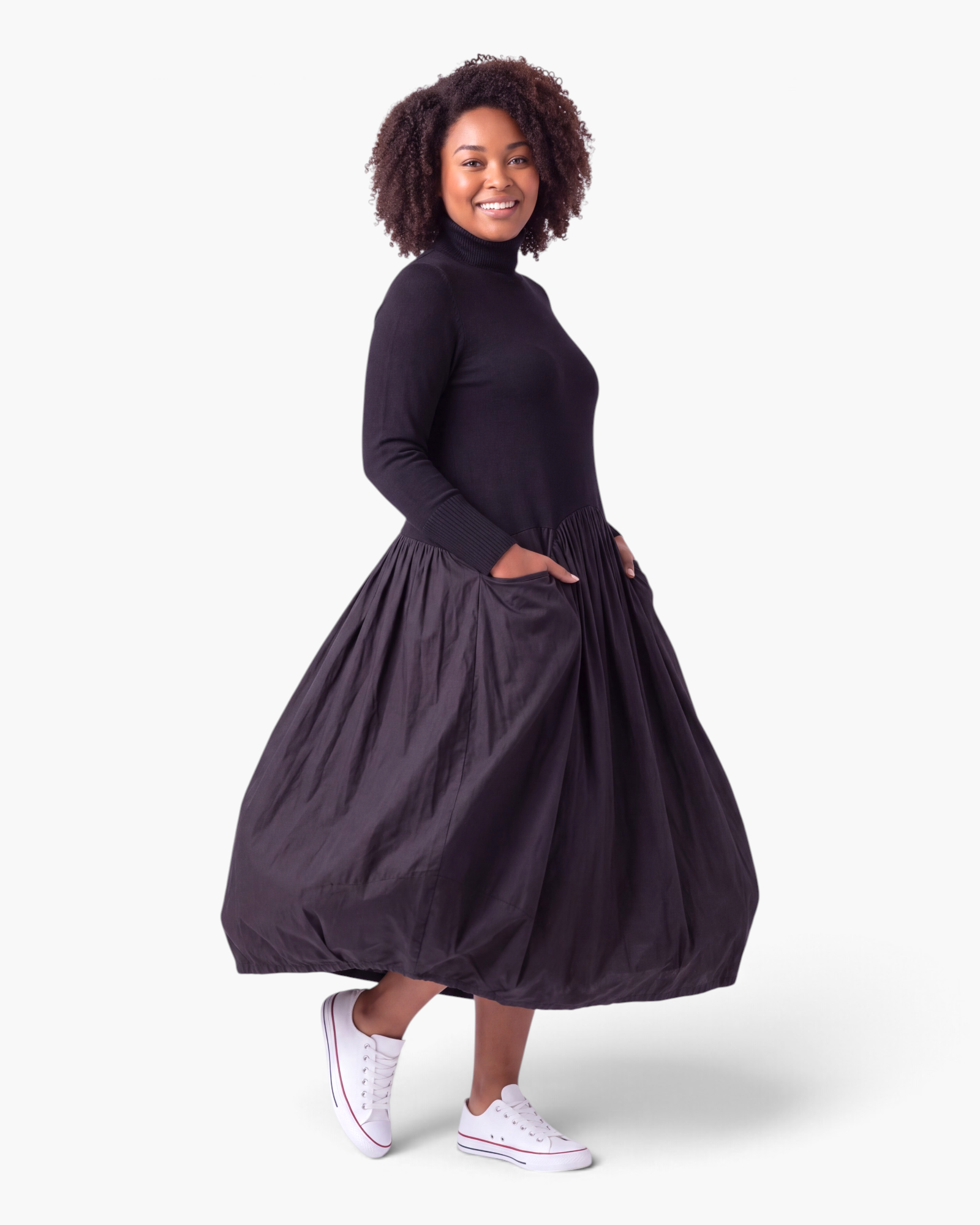 Beach Rose Co. black turtleneck maxi dress with a sweater bodice, gathered skirt, side pockets, and balloon hem.