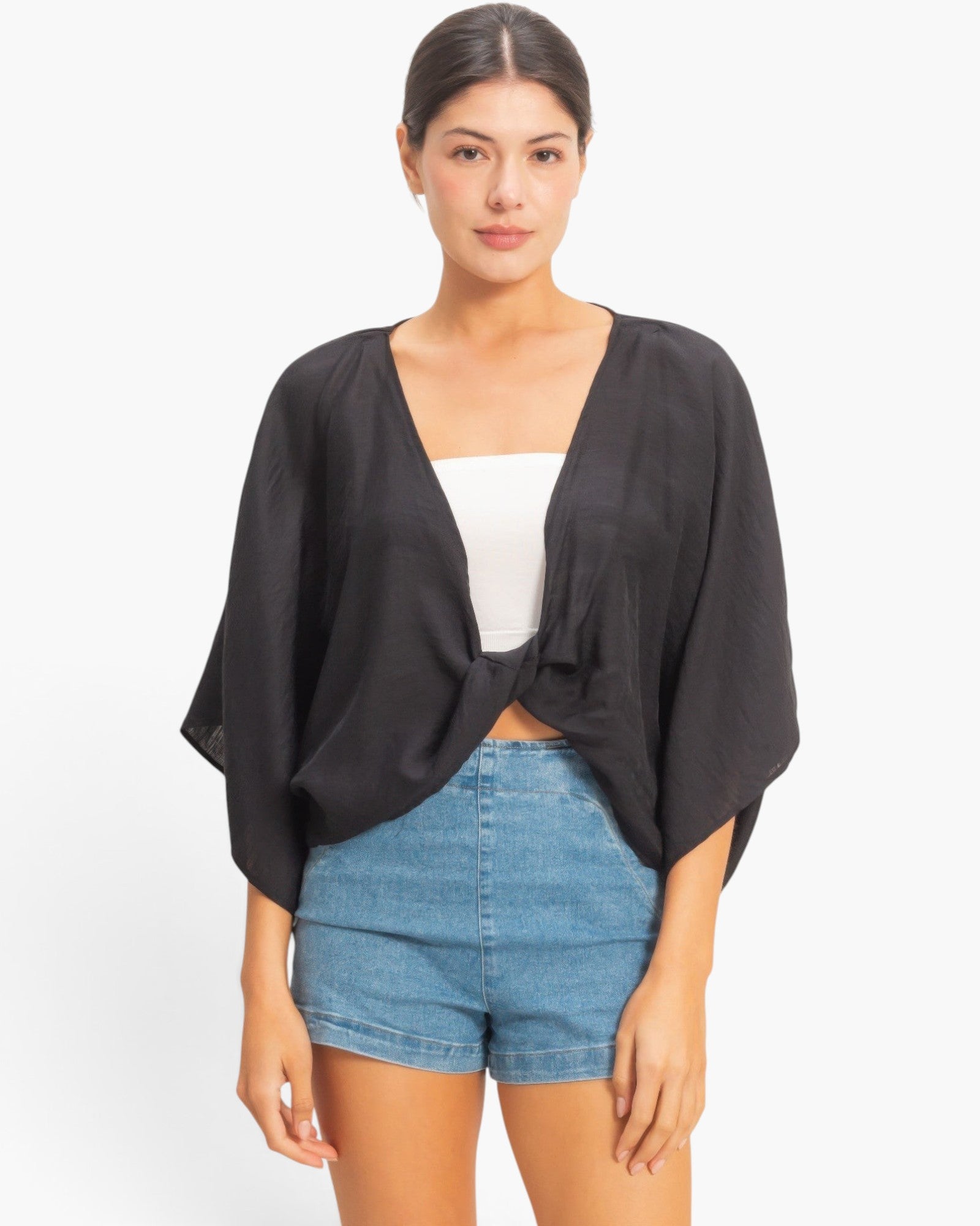 Beach Rose Co. black oversized twist knot top with deep V-neck and loose sleeves worn over a white camisole