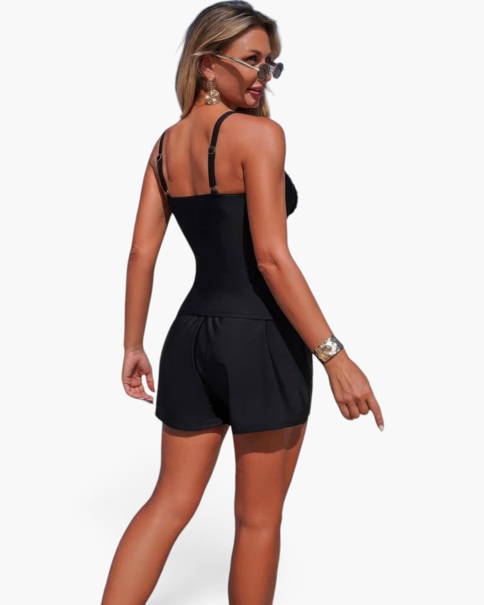 Beach Rose Co. black two-piece swimsuit with sling straps, pleated shorts, and pocket accents on a model