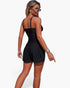 Beach Rose Co. black two-piece swimsuit with sling straps, pleated shorts, and pocket accents on a model