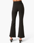 Beach Rose Co. black high-rise flare pants with a crossover V-waist, shown from the back on a model.