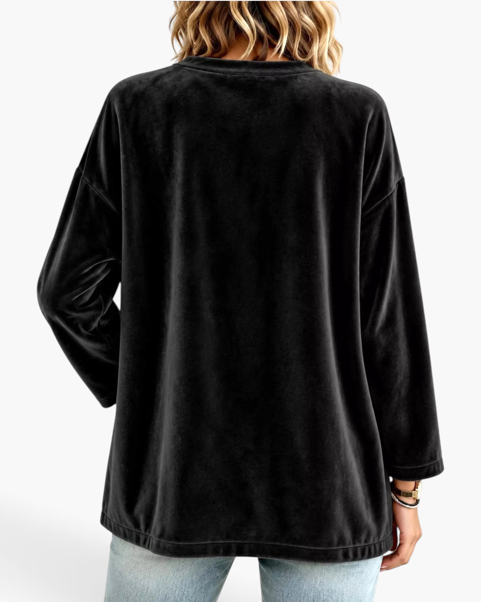 Back view of a Beach Rose Co. black velour cardigan with a relaxed fit and dropped shoulders on a model.