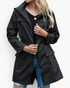 Beach Rose Co. black waterproof hooded rain jacket with zip front, flap pockets, and gathered waist on a model