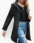 Beach Rose Co. black waterproof hooded rain jacket with zip front, drawstring hood, and gathered waist on a model.
