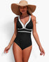 Beach Rose Co. one-piece swimsuit in black and white with a V-neckline, worn by a woman with a wide-brim straw hat.